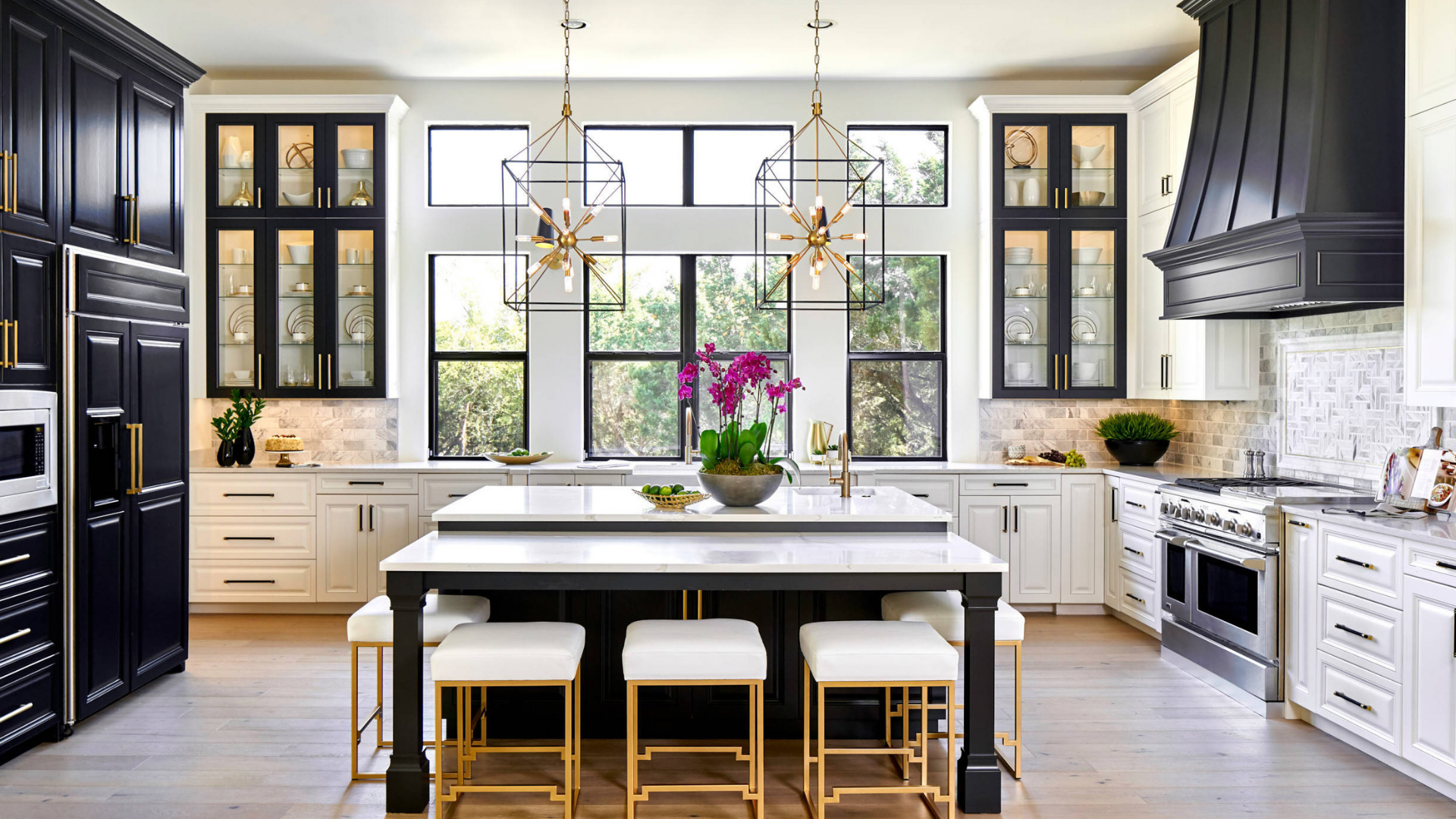 Elegant black and white kitchen with marble island and pendant lighting