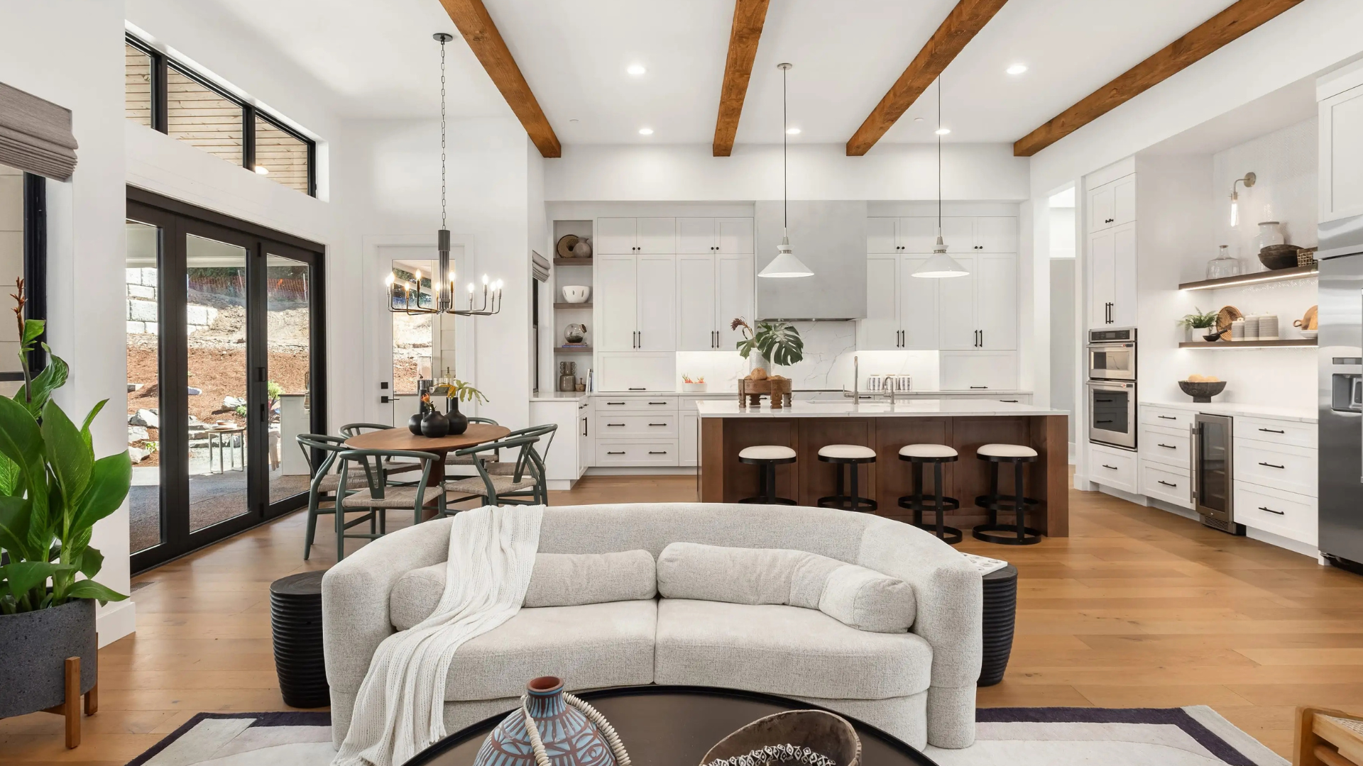 Elegant modern kitchen and living room interior with wood beams
